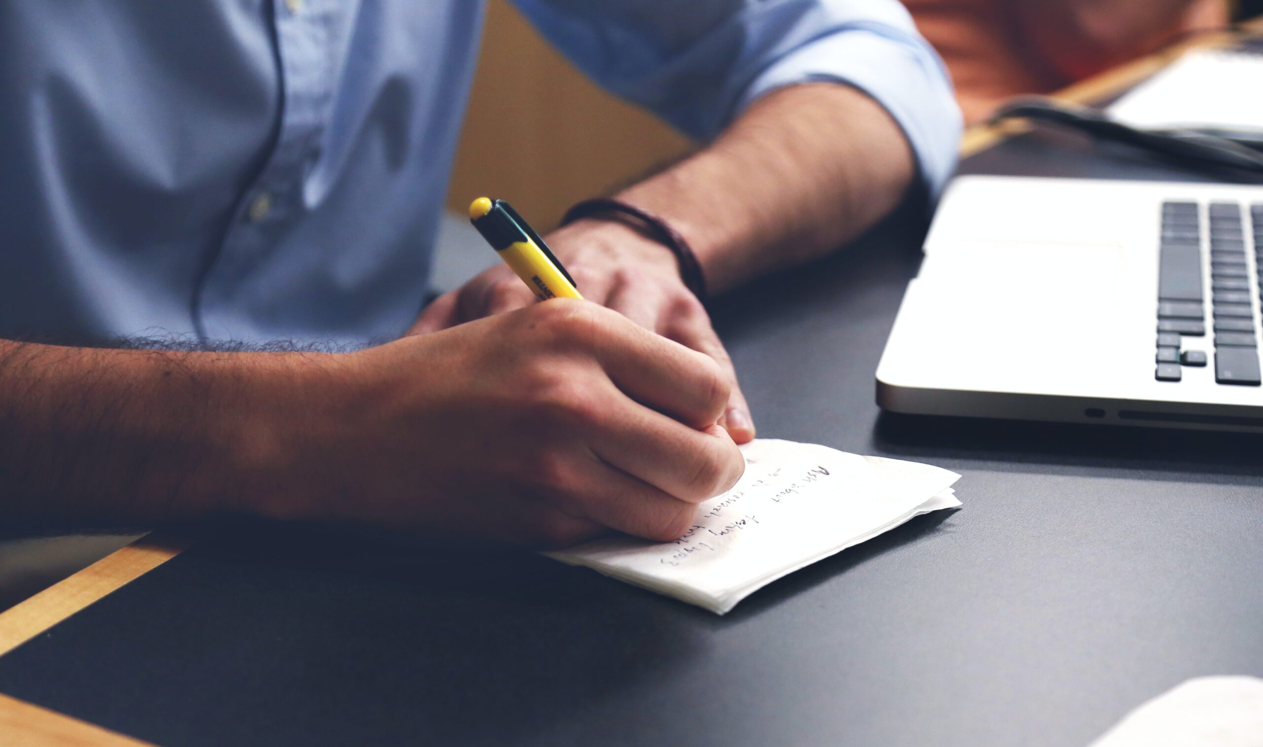 Person taking notes during a candidate interview